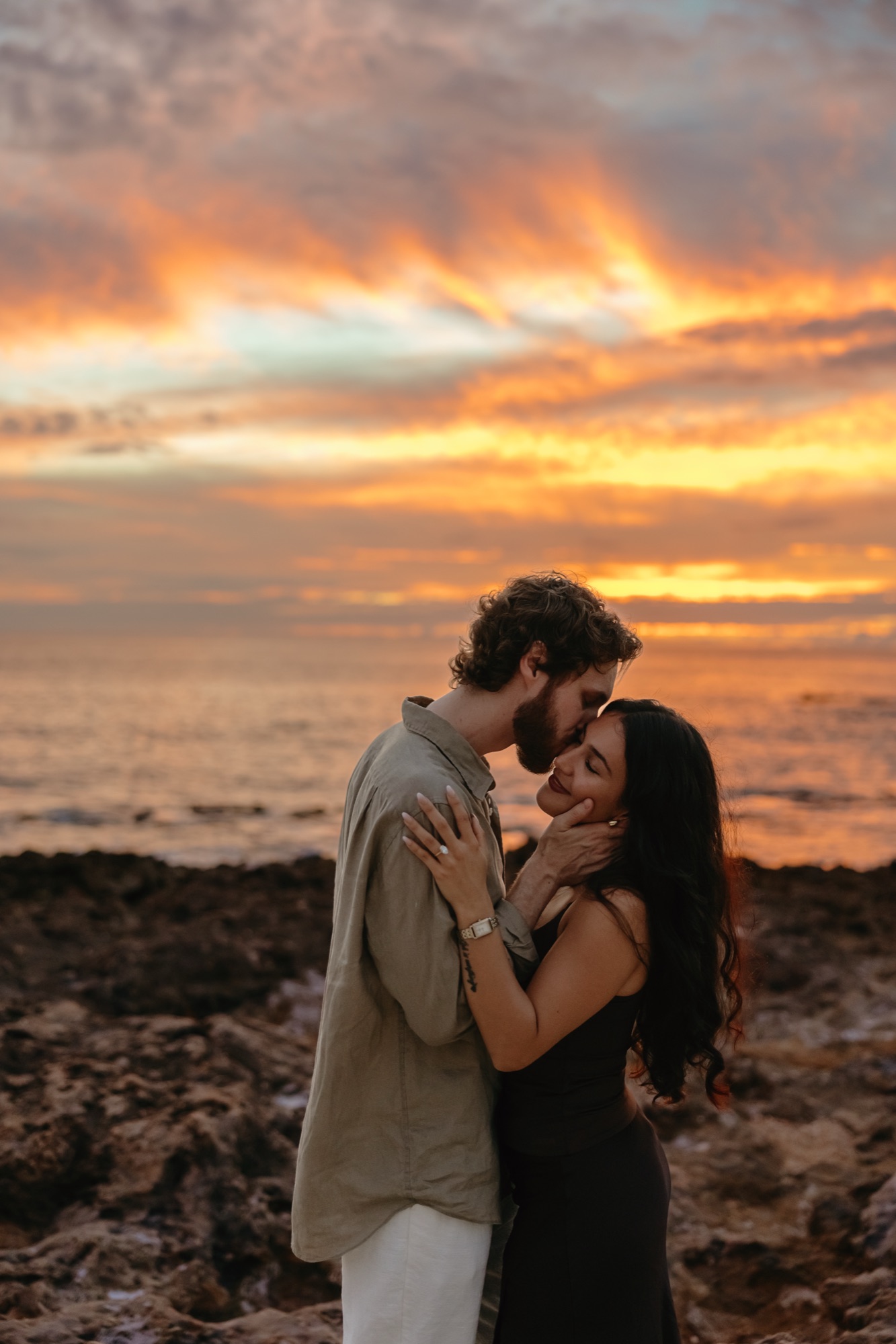 Sean kissing Valeria at sunset by the ocean